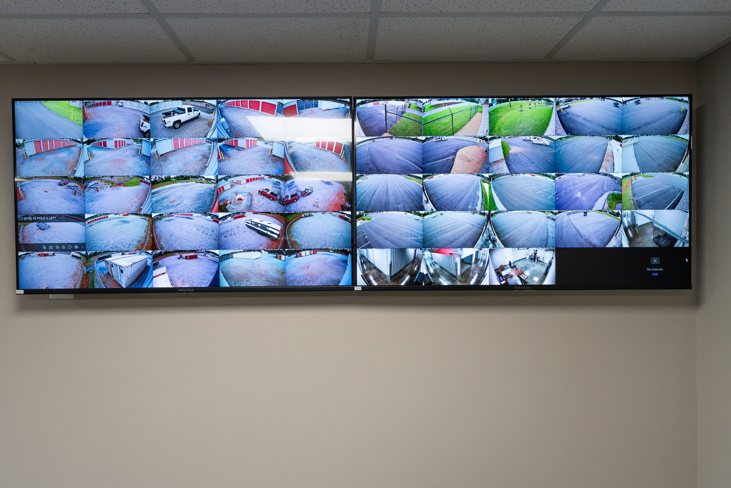 Office monitors showing live security camera feeds across the property