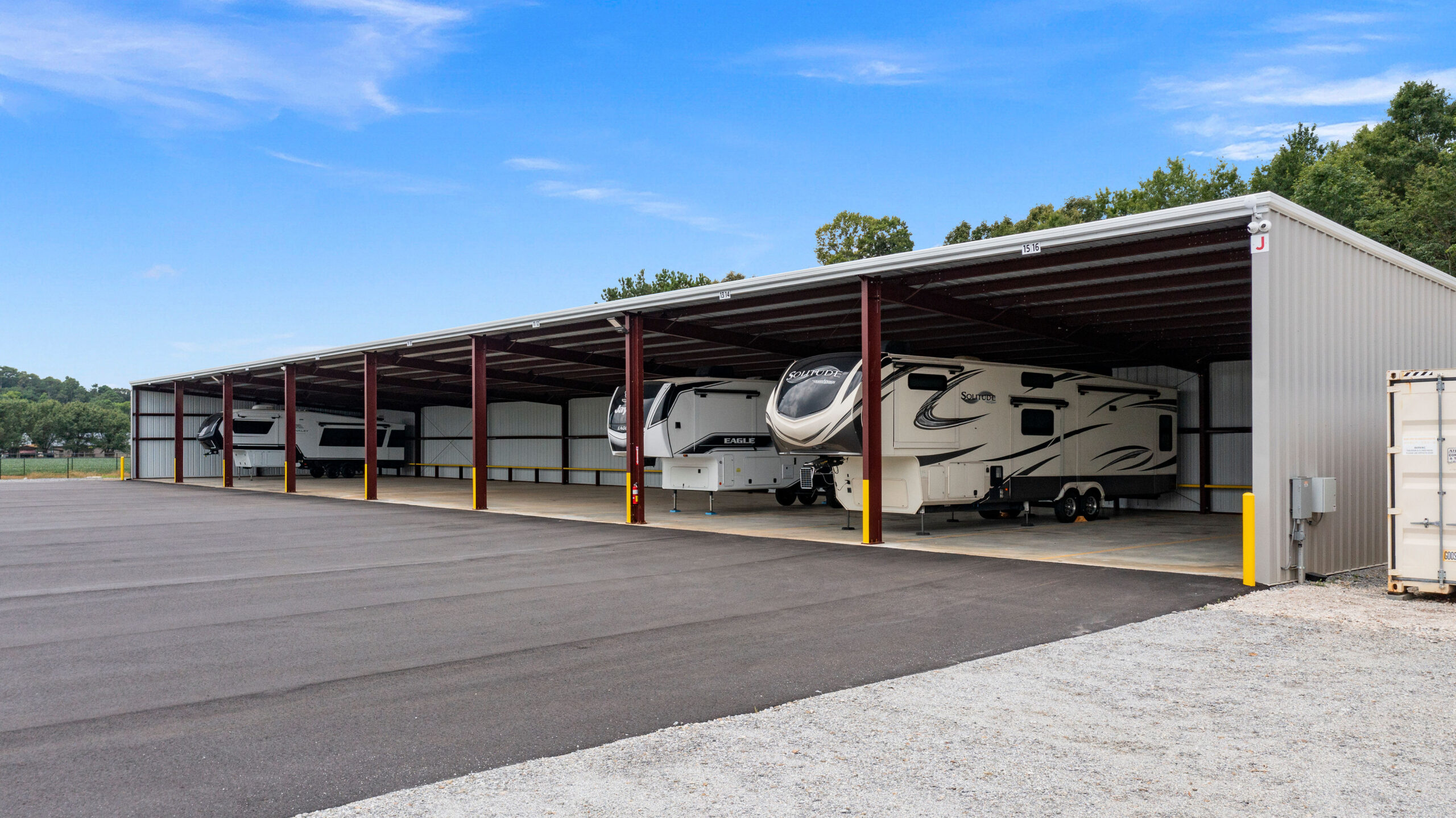 Row of RVs parked under the covered parking structure