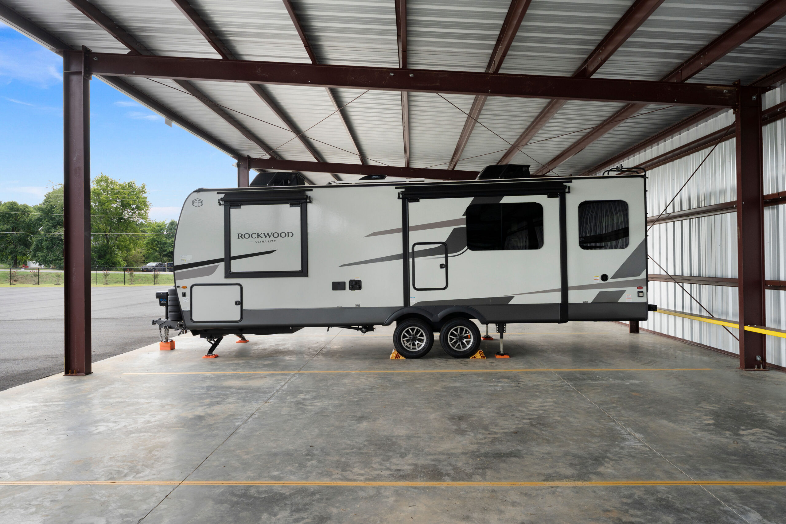 Travel trailer parked in a covered RV parking space